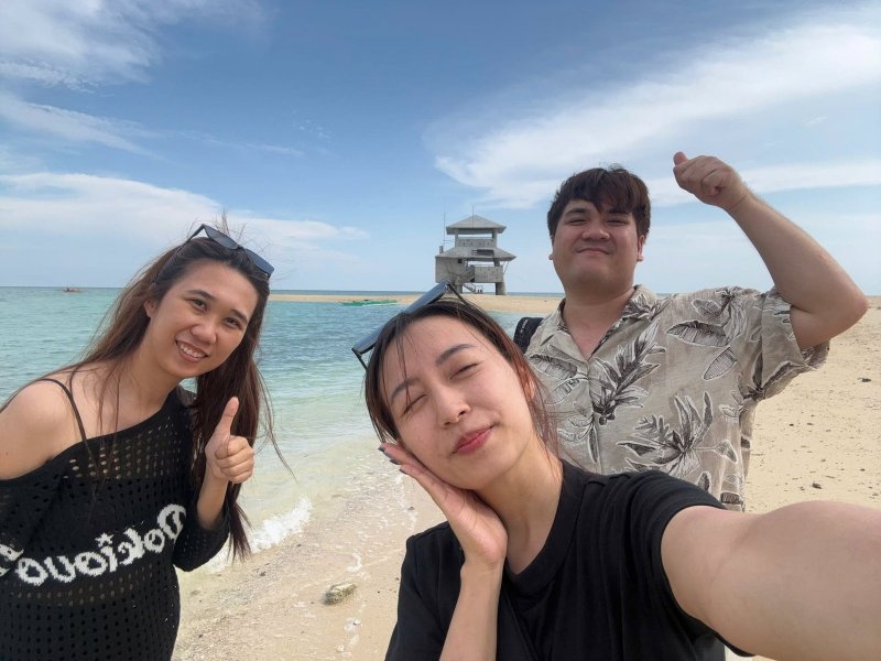 菲律賓的白沙灘與清澈淺海前,三人自拍合照